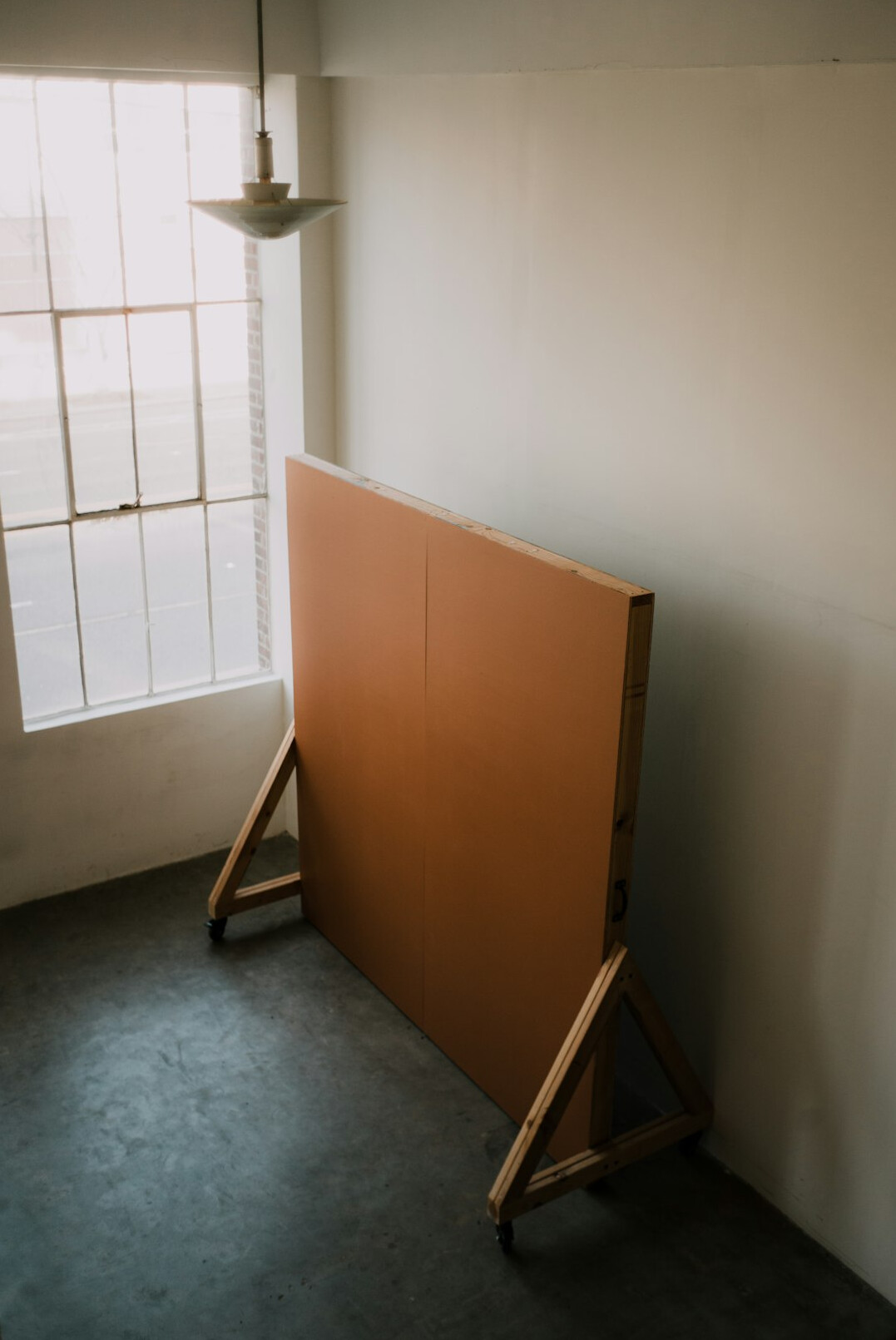 Crew organizing furniture and backdrop in a studio